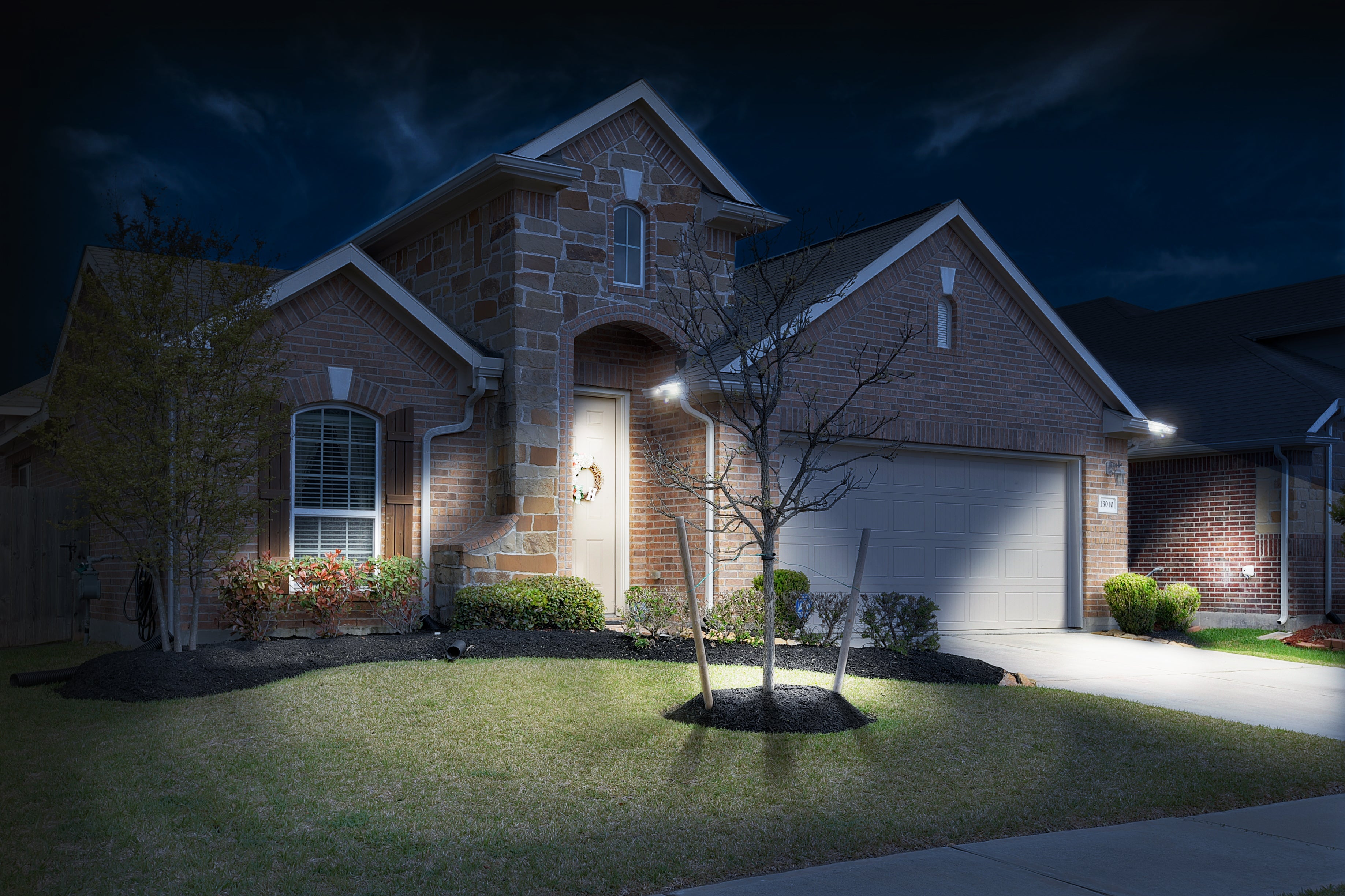 Brick and stone house from the curb after gutter lighting picture