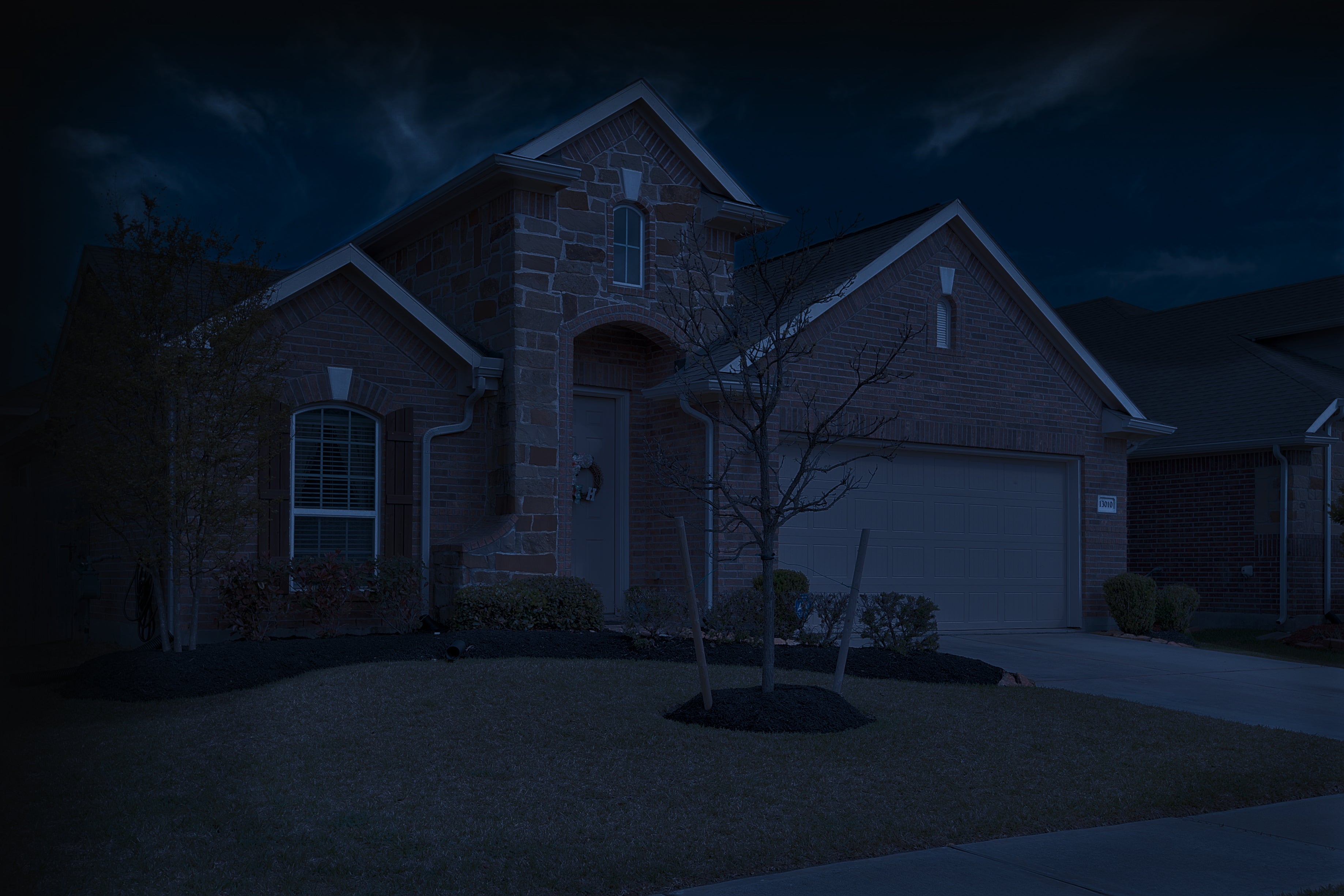 Brick and stone house from the curb before gutter lighting picture