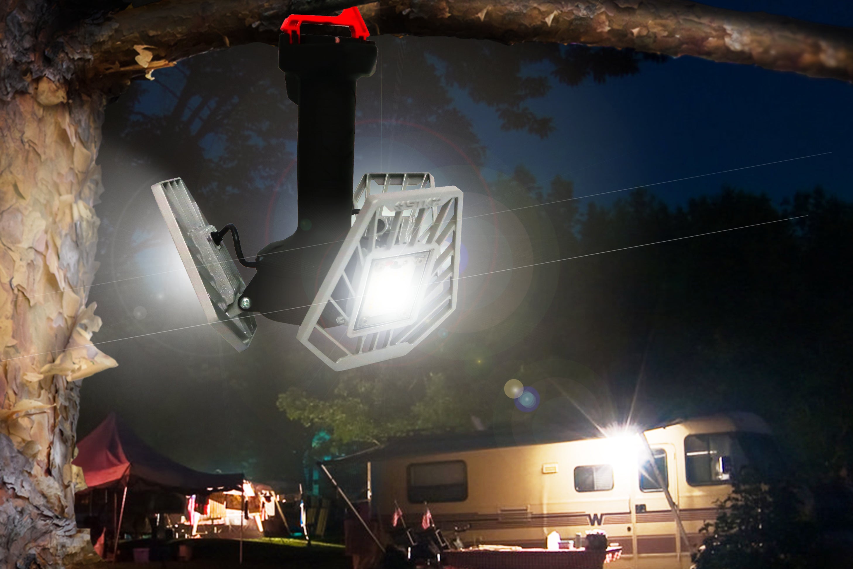 STKR Concepts' Tri-light Shoplight v2 hanging from a tree a night with an RV camping scene in the background