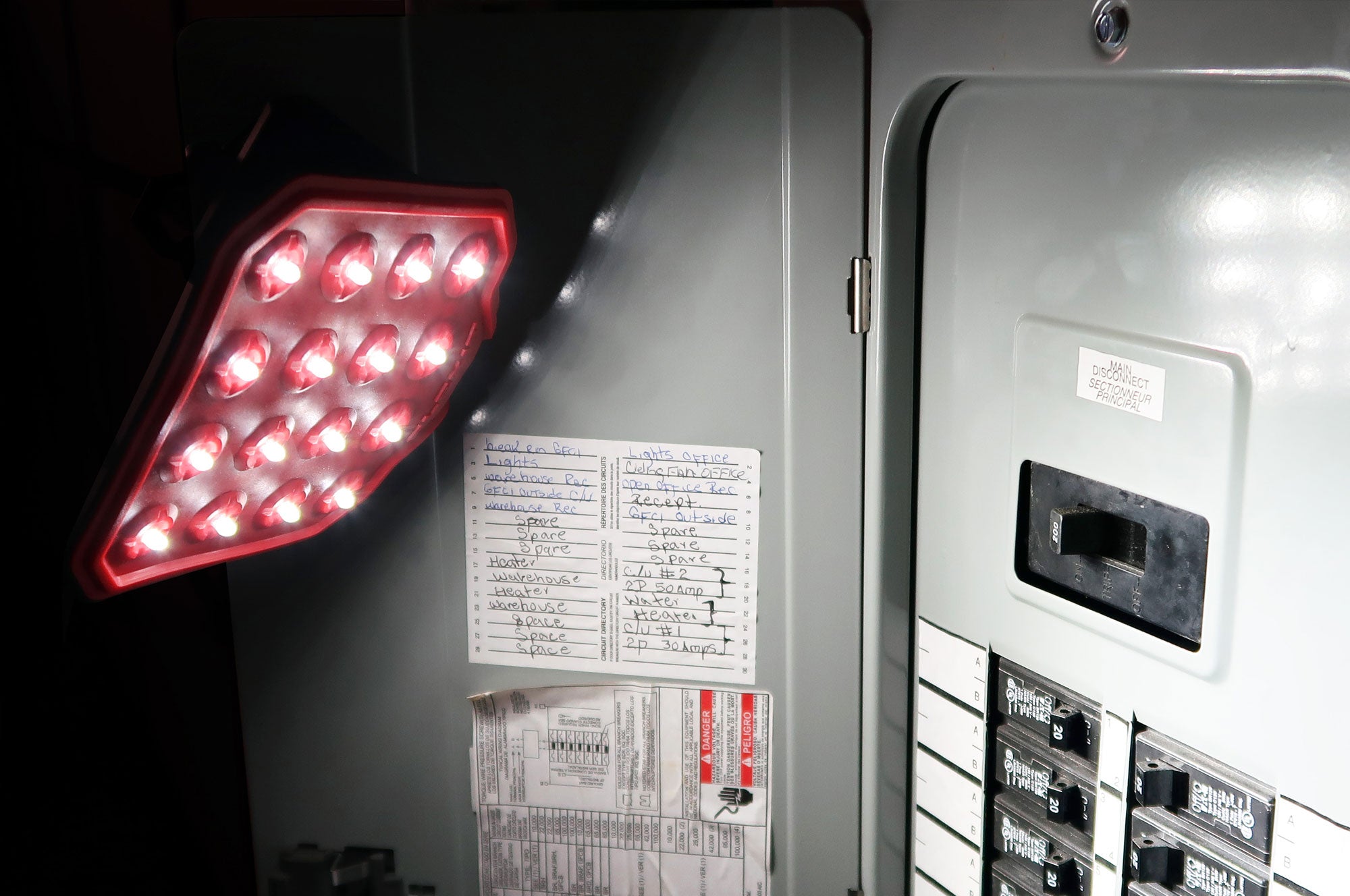 use pic of a FLEXIT 2.0 magnetically attached to a power panel lighting up the breaker switches