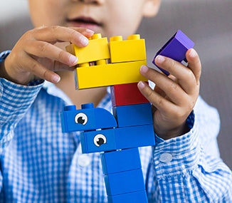 Child playing with building blocks