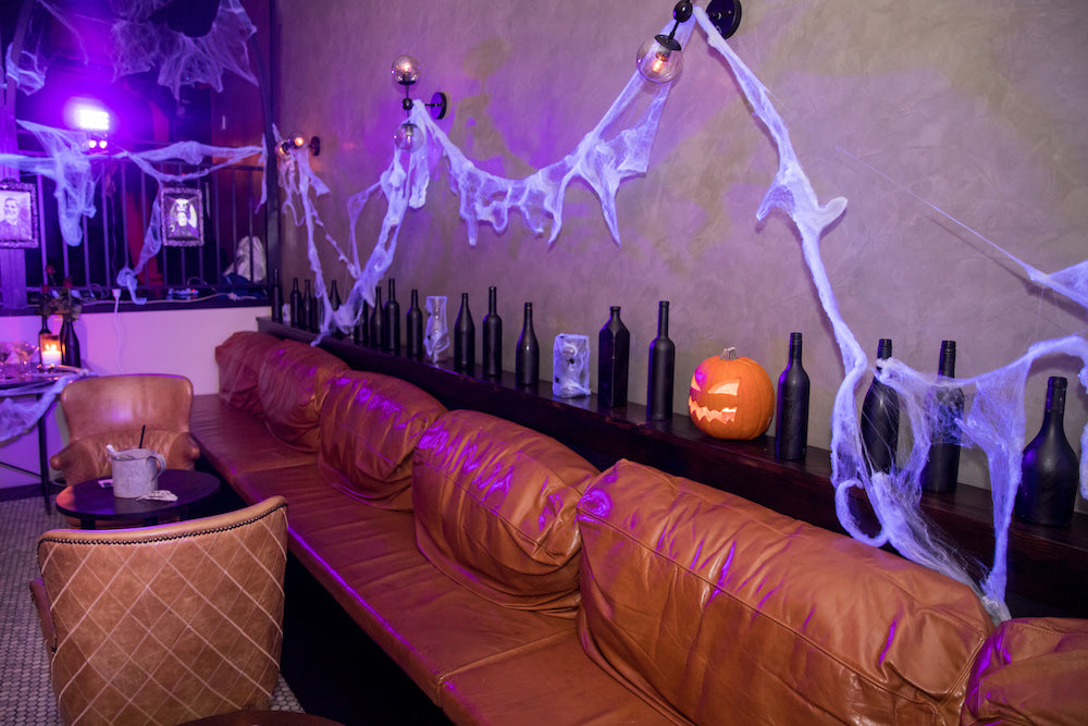 Halloween Decorations: bottles, jack-o’-lantern and spider web wall feature