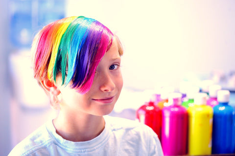 Young boy celebrating his uniqueness with creative hair colours