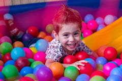 Wellbeing articles - Happy boy playing in a children’s ball pit
