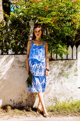 girl standing under tree wearing rayelle midi dress
