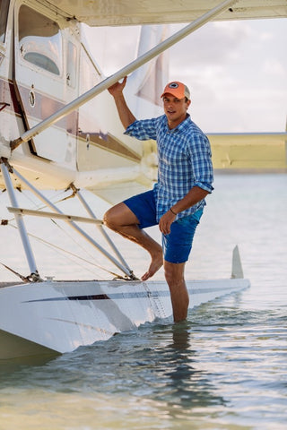 man standing on water plane wearing short sleeve button down