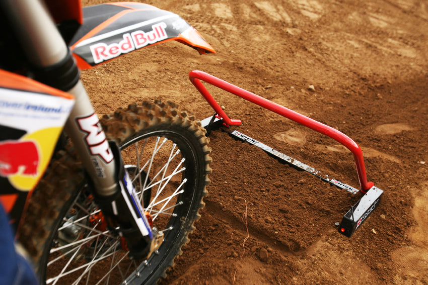 Extreme close up of a tire and front fender of a dirt bike waiting for their Holeshot race gate to drop