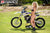 September's Risk Racing Moto Model Denna Lynn posing in various bikinis & Risk Racing Jerseys next to a dirt bike that's sitting on a Risk Racing ATS stand - Pose #15
