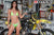 August's Risk Racing Moto Model Samantha Heady posing in various bikinis & Risk Racing Jerseys next to a dirt bike that's sitting on a Risk Racing ATS stand - Pose #33