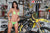 August's Risk Racing Moto Model Samantha Heady posing in various bikinis & Risk Racing Jerseys next to a dirt bike that's sitting on a Risk Racing ATS stand - Pose #40
