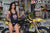 August's Risk Racing Moto Model Samantha Heady posing in various bikinis & Risk Racing Jerseys next to a dirt bike that's sitting on a Risk Racing ATS stand - Pose #6