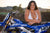 December's Risk Racing Moto Model Kelly Perez posing in various bikinis and Risk Racing Jerseys next to a dirt bike that's sitting on a Risk Racing ATS stand - Pose #29