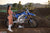December's Risk Racing Moto Model Kelly Perez posing in various bikinis and Risk Racing Jerseys next to a dirt bike that's sitting on a Risk Racing ATS stand - Pose #6