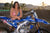December's Risk Racing Moto Model Kelly Perez posing in various bikinis and Risk Racing Jerseys next to a dirt bike that's sitting on a Risk Racing ATS stand - Pose #8