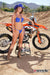 October's Risk Racing Moto Model Dani Hamilton posing in various bikinis and Risk Racing Jerseys next to a dirt bike that's sitting on a Risk Racing ATS stand - Pose #23