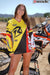 October's Risk Racing Moto Model Dani Hamilton posing in various bikinis and Risk Racing Jerseys next to a dirt bike that's sitting on a Risk Racing ATS stand - Pose #7