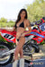 July's Risk Racing Moto Model Samantha Heady posing in various bikinis & Risk Racing Jerseys next to Alex Ray's Honda CR250R that's sidding on a Risk Racing ATS stand - Pose #10