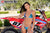 July's Risk Racing Moto Model Samantha Heady posing in various bikinis & Risk Racing Jerseys next to Alex Ray's Honda CR250R that's sidding on a Risk Racing ATS stand - Pose #17