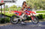 July's Risk Racing Moto Model Samantha Heady posing in various bikinis & Risk Racing Jerseys next to Alex Ray's Honda CR250R that's sidding on a Risk Racing ATS stand - Pose #18