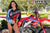 July's Risk Racing Moto Model Samantha Heady posing in various bikinis & Risk Racing Jerseys next to Alex Ray's Honda CR250R that's sidding on a Risk Racing ATS stand - Pose #27