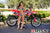 July's Risk Racing Moto Model Samantha Heady posing in various bikinis & Risk Racing Jerseys next to Alex Ray's Honda CR250R that's sidding on a Risk Racing ATS stand - Pose #6