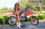 July's Risk Racing Moto Model Samantha Heady posing in various bikinis & Risk Racing Jerseys next to Alex Ray's Honda CR250R that's sidding on a Risk Racing ATS stand - Pose #9