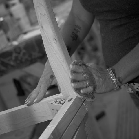 A Cudo Dining Chair frame being sanded on the plant floor in USA