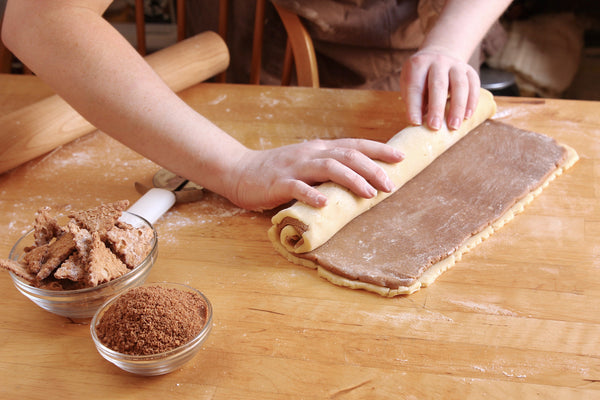 Rolling up pinwheel cookies with original cannoli chips