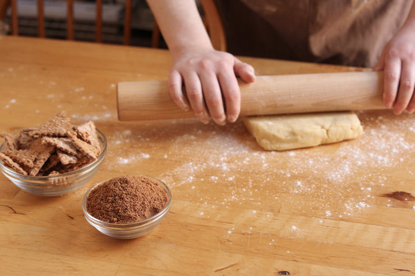 Rolling vanilla dough for cinnamon cannoli pinwheel cookies