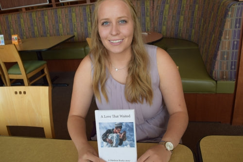Rachel holding her book for people with dementia