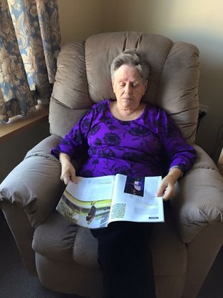 woman with dementia reading a book