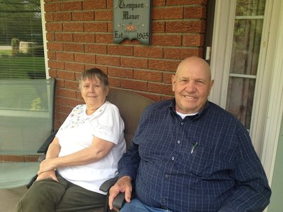 elderly couple sitting outside