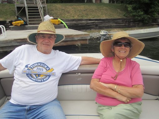 man and wife with dementia on boat smiling