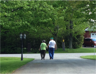 elderly couple walking in a park