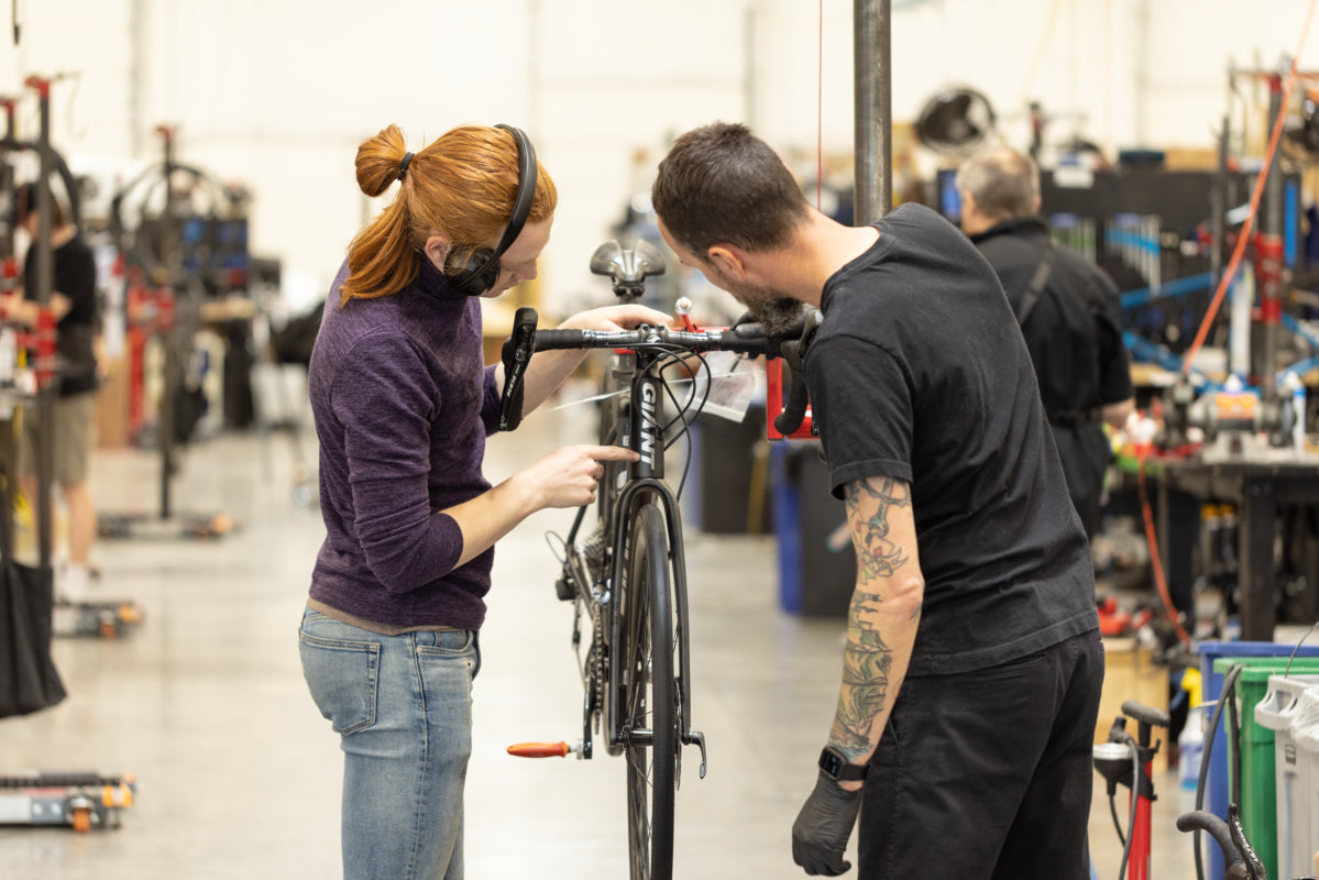 Mechanic working on a bike at The Pro's Closet