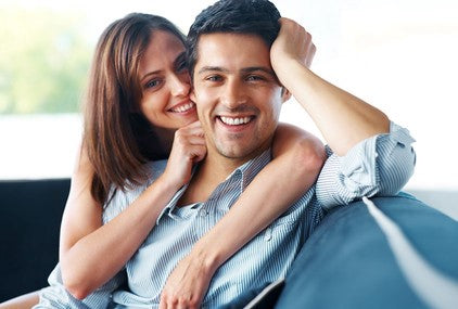 Happy Smiling Couple On A Sofa Lounge