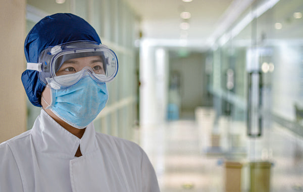 woman in white dress shirt wearing face mask