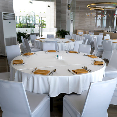 white round tablecloth with a golden table napkin