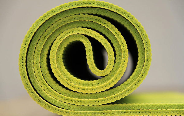 green fabric yoga mat