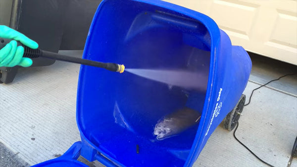 Cleaning Garbage Cans with a pressure sprayer