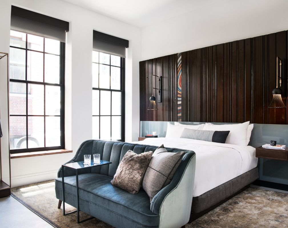 The Detroit Foundation hotel’s 100 guestrooms each ​feature a headboard wall made entirely of repurposed wood. 