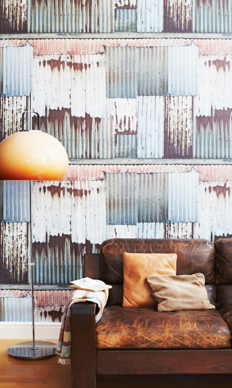 Ella Doran's Corrugated Chic wallpaper design with a brown leather sofa. Photo by Rita Platts
