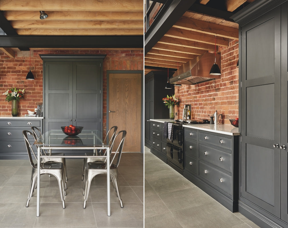 Industrial Shaker style kitchen in charcoal grey. The cabinetry contrasts with the exposed brick wall. Kitchen by Tom Howley. 