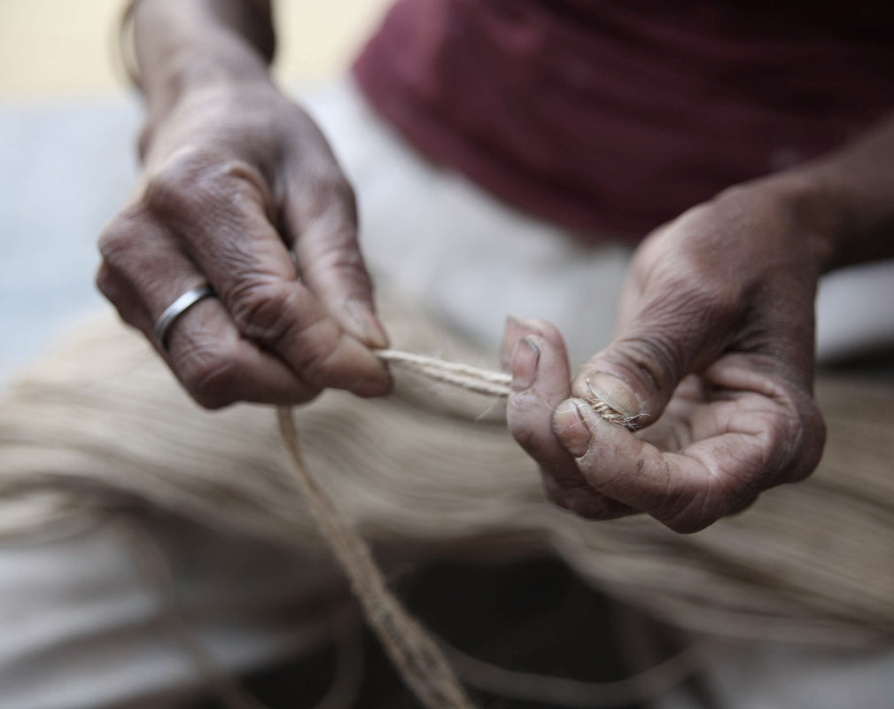 Nkuku works with skilled artisans who hand sew the jute rugs