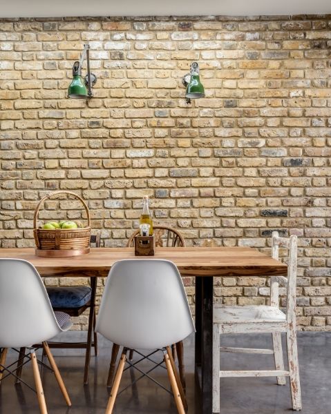Exposed brick walls and industrial wall lighting are the main features of this dining area