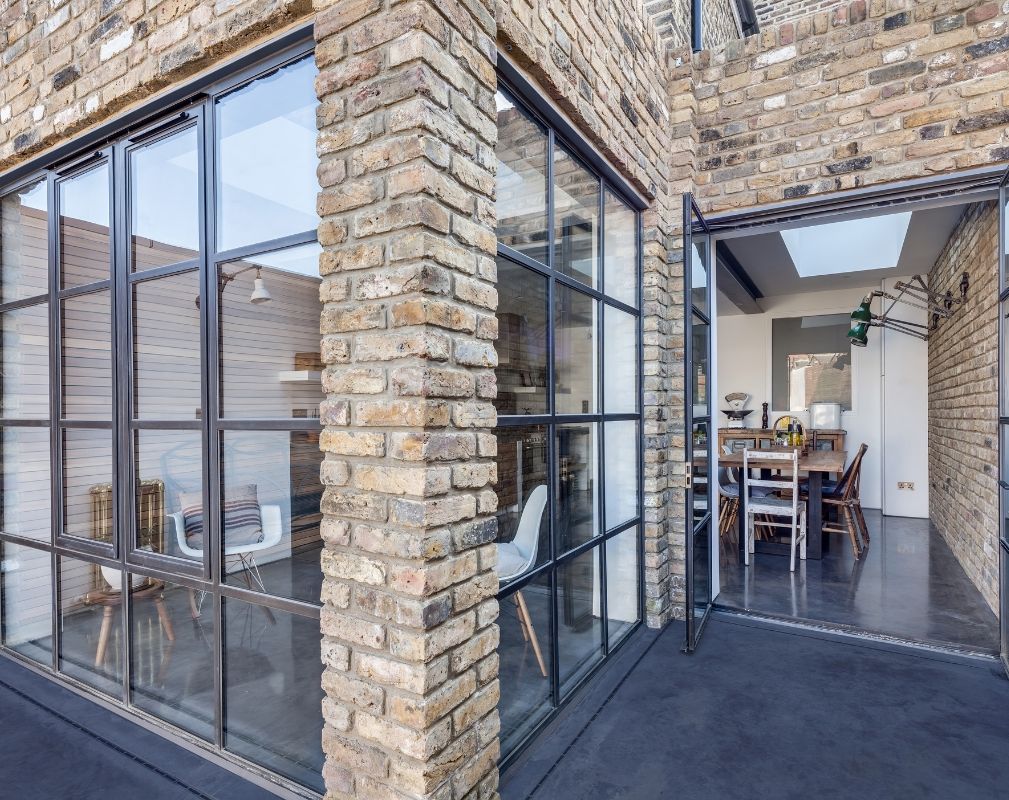 Large Crittall style windows and doors are a real style statement in the extension of this period property renovated by Paper House Project