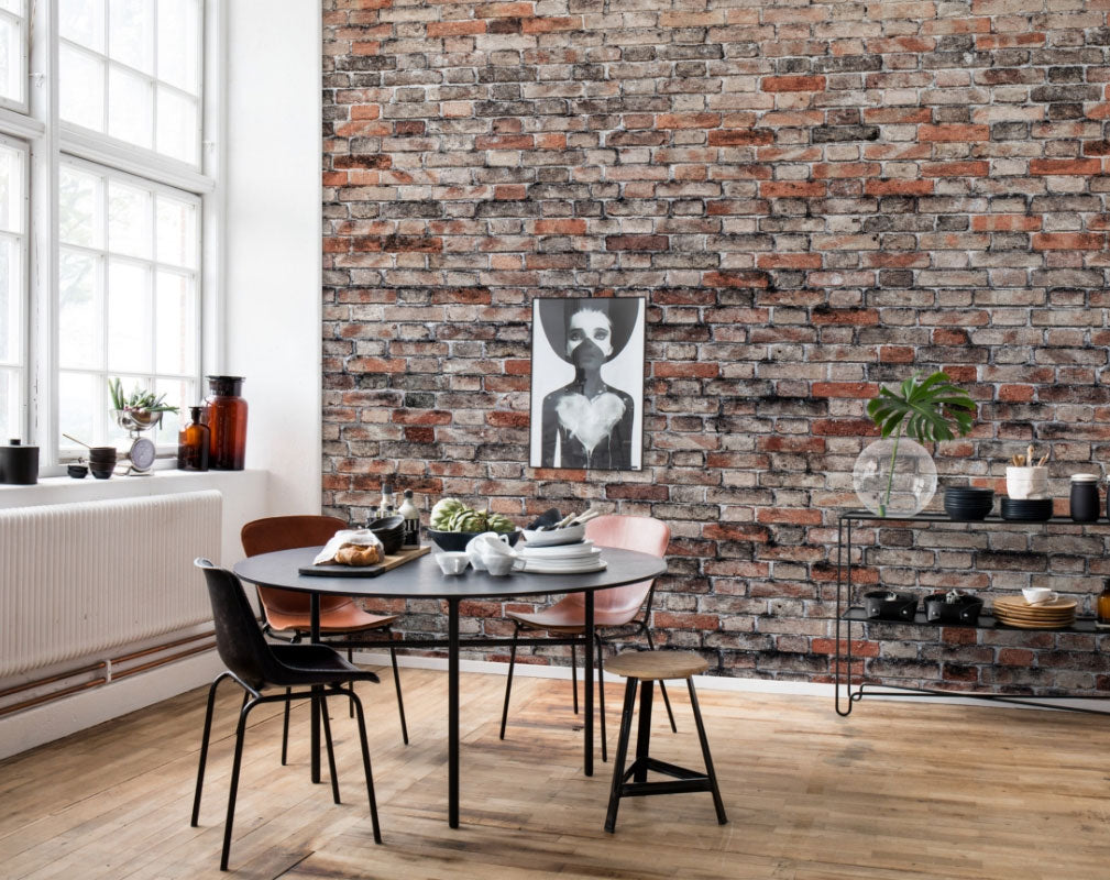 Exposed brick wallpaper by Rebel Walls used in a warehouse dining room setting