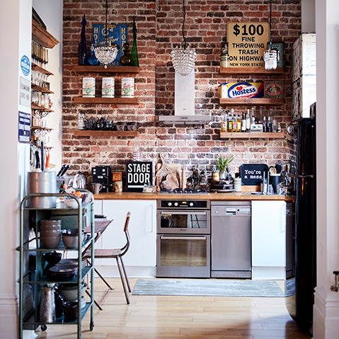 industrial kitchen scheme with exposed brick feature wall