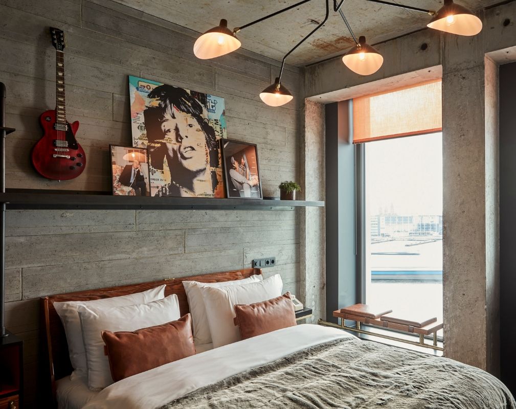 The Sir Adam Hotel in Amsterdam. The luxury guestrooms feature raw concrete columns, exposed ceilings and floor-to-ceiling windows