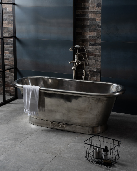 Industrial style bathroom featuring a freestanding nickel bathtub, Crittall Style shower screen and large format metal effect blue tiles from Original Style